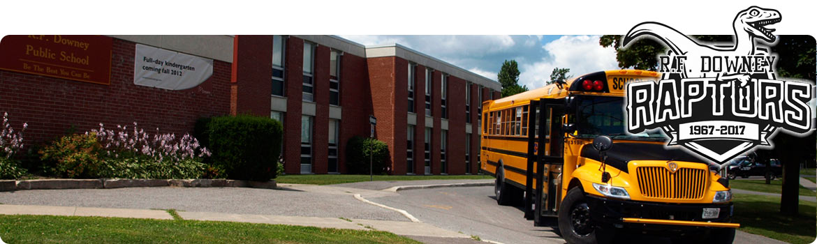 This is a picture of the front of our school with a school bus parked in the driveway.
